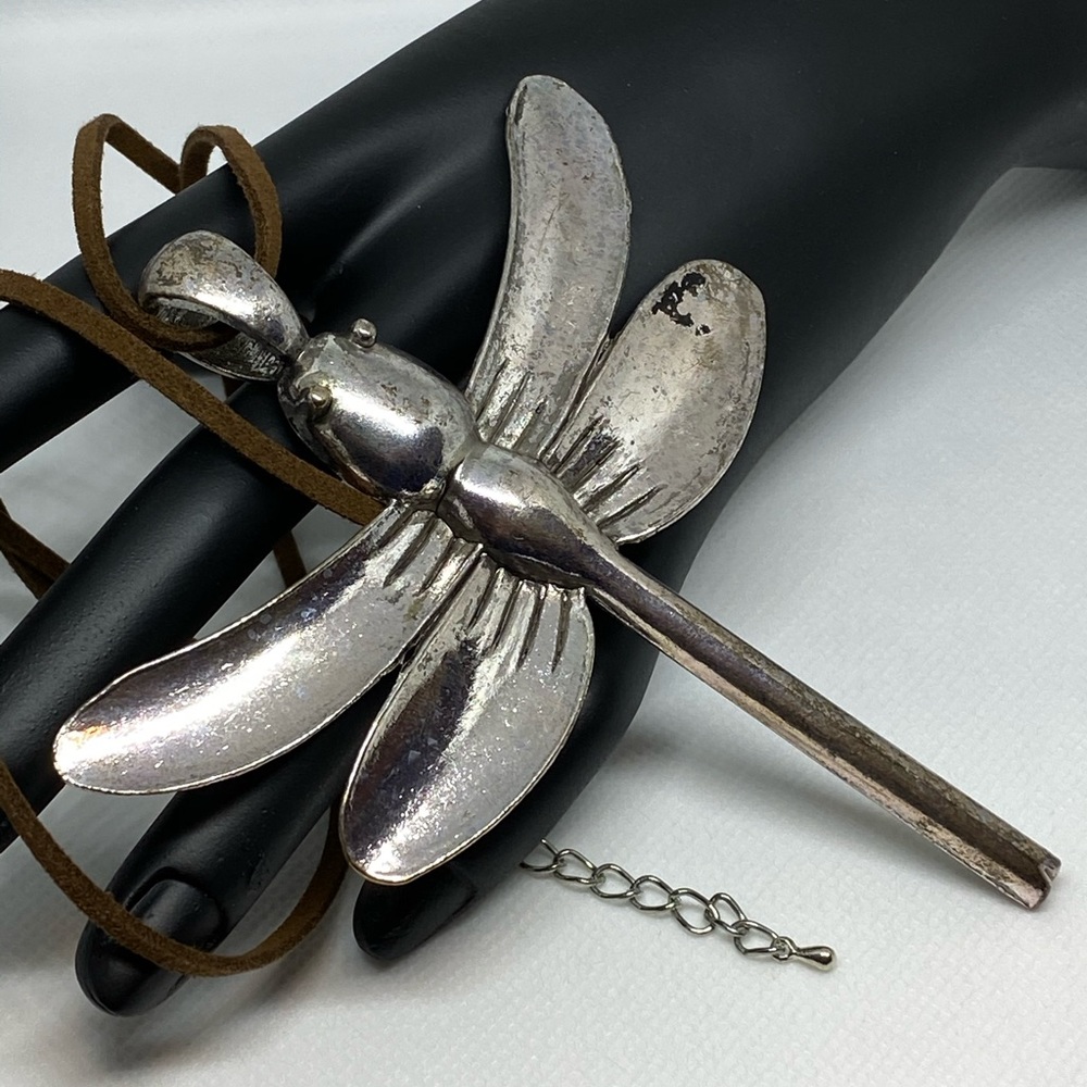 Metal dragonfly pendant.